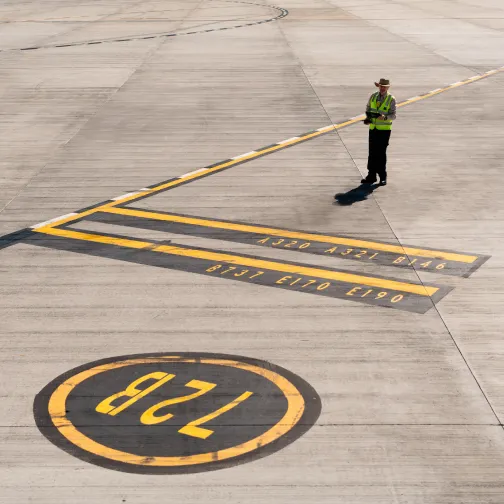 An airport employee on a plane runway