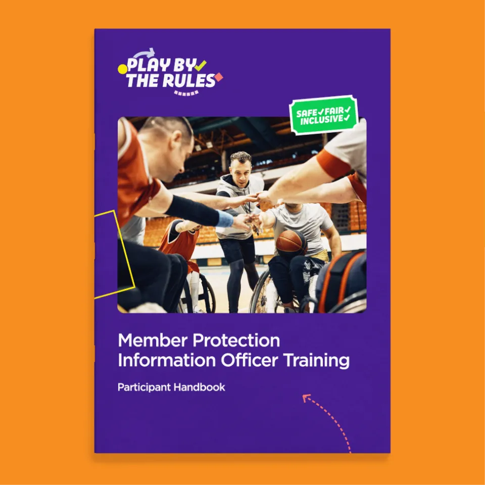 A Play by the Rules booklet about MPIO training. It sits on an orange background and has a huddling wheelchair basketball team on the front